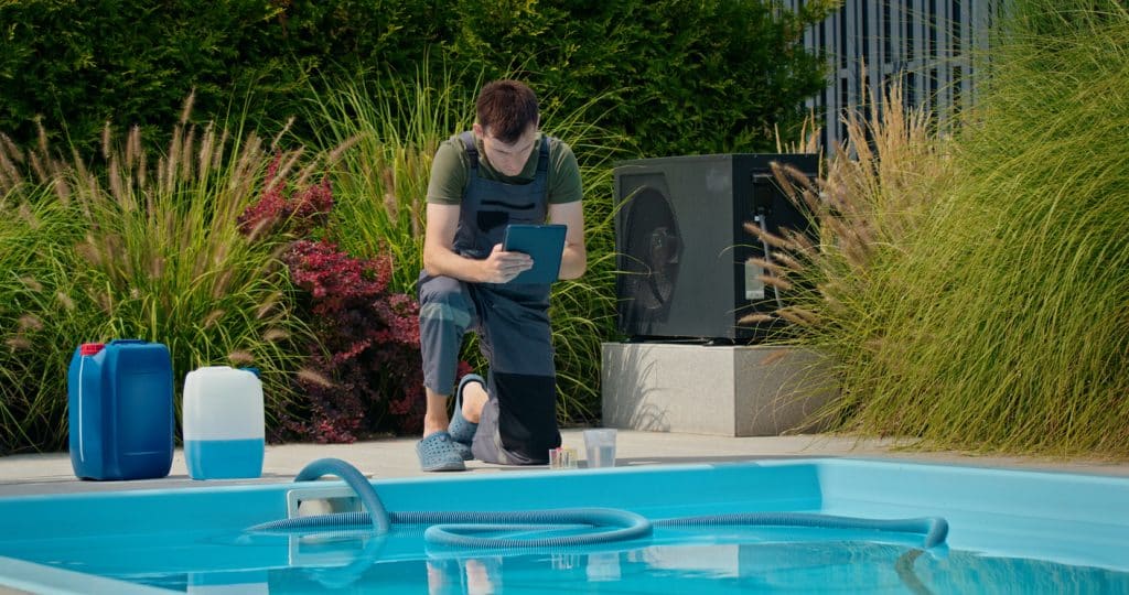 Pool technician checking data on a tablet