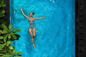 Woman Relaxing In Swimming Pool